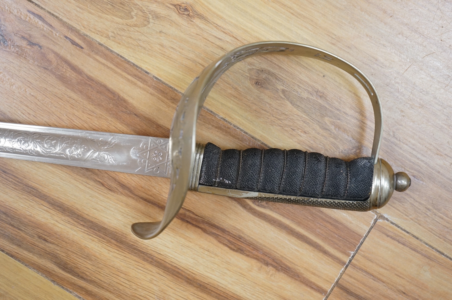 A George V 1897 pattern infantry officer’s sword, with regulation blade etched with the union flowers, Royal Arms and owners name; J.W. Reynolds, Dorrington, Lincoln, regulation nickel guard stamped ‘WH&S’ in minuscules,